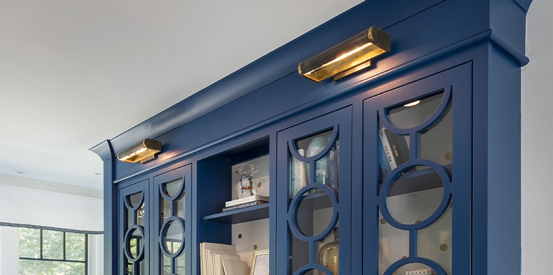 Brass picture light mounted over built-in bookcase