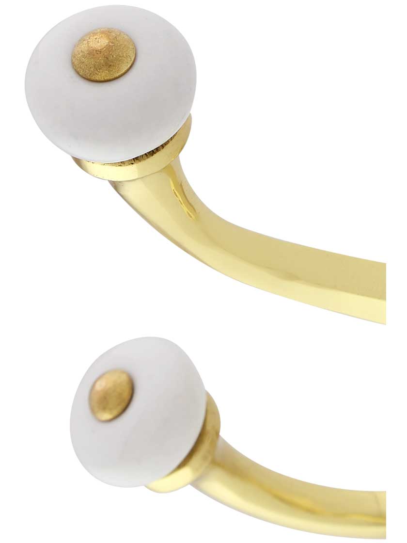 Double Coat Hook with Porcelain Ball Tips In Lacquered Brass