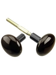 Pair of Brown Porcelain Doorknobs With Black Iron Shanks.