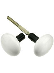 Pair of White Porcelain Doorknobs With Black Iron Shanks.