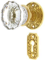 Scroll Rosette Mortise Lock Set with Fluted Glass Door Knobs in Un-Lacquered Brass.