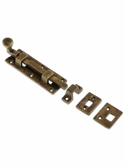 Cast Bronze Door Bolt With Curled Handle in Weathered Bronze.