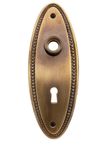 Solid-Brass Beaded Oval Door Plate with Keyhole in Antique-By-Hand.