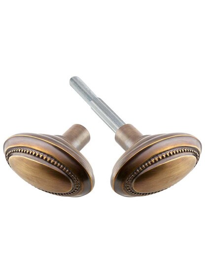 Pair of Solid-Brass Beaded Oval Door Knobs in Antique-By-Hand.
