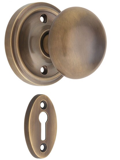 Classic Rosette Mortise-Lock Set with Round Brass Knobs in Antique-By-Hand.
