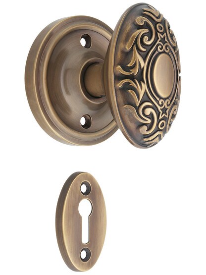 Classic Rosette Mortise Lock Set with Decorative Oval Knobs in Antique-By-Hand.