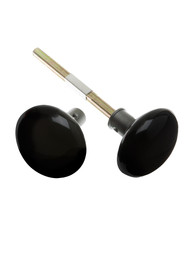 Pair of Black Porcelain Rim Lock Knobs With Solid Iron Shanks In Antique Iron.