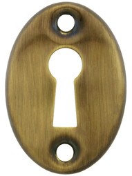 Stamped Brass Oval Keyhole Cover in Antique-By-Hand Finish.