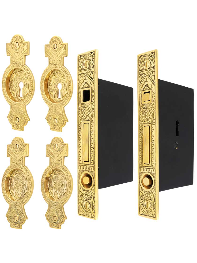 Oriental Bit-Key Double Pocket Door Mortise-Lock Set in Unlacquered Brass.