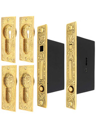 Broken Leaf Bit-Key Double Pocket Door Mortise-Lock Set in Unlacquered Brass.