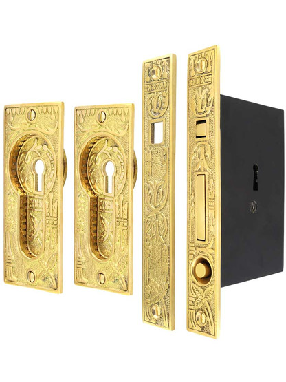 Broken Leaf Bit-Key Single Pocket Door Mortise-Lock Set in Unlacquered Brass.
