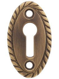 Rope Pattern Brass Keyhole Cover in Antique-By-Hand - 1 7/8 inch x 1 1/8 inch.
