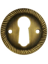 Stamped Brass Round Keyhole Cover with Rope Design in Antique-By-Hand Finish.