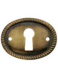 Oval Horizontal Rope-Pattern Brass Keyhole Cover in Antique-By-Hand - 1 1/8" x 1 1/2"