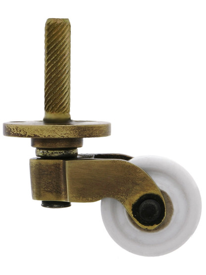 Solid Brass Stem-and-Plate Caster with Porcelain Wheel in Antique-by-Hand.