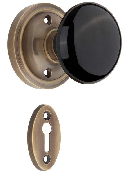 Classic Rosette Mortise-Lock Set with Black Porcelain Knobs in Antique-By-Hand.