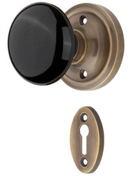 Classic Rosette Mortise-Lock Set with Black Porcelain Knobs in Antique-By-Hand.