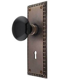 Ovolo Mortise-Lock Set with Black Porcelain Knobs and Keyhole in Antique-by-Hand.