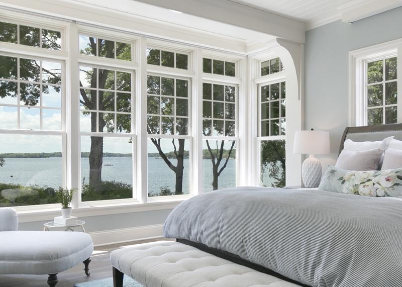 Beautifully restored windows brighten this sunny bedroom.