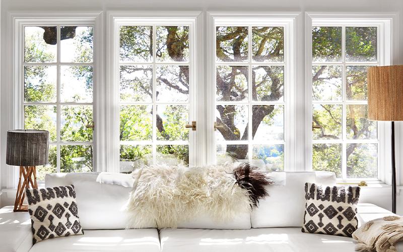 A row of casement windows opens a room to the outdoors.