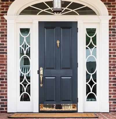 Polished brass kickplate with matching brass entry set and knocker.