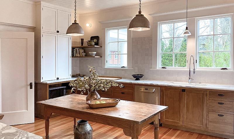 Newly recreated kitchen in a 1909 home features bronze bin pulls and latches, and vintage pendant lighting