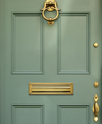 Classic brass mail slot mounted to door