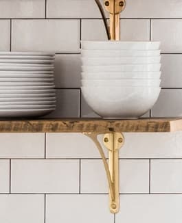 Create shelving with brass, iron, or wood shelf brackets