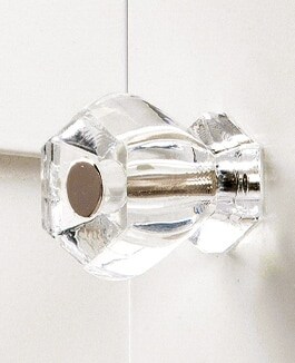 Cabinet knobs in glass, brass, and iron