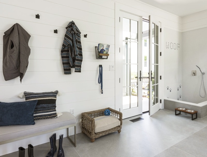 Large mudroom with hooks and dog-washing statiion