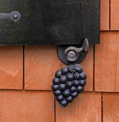 Cast iron grape design post mount shutter dog.